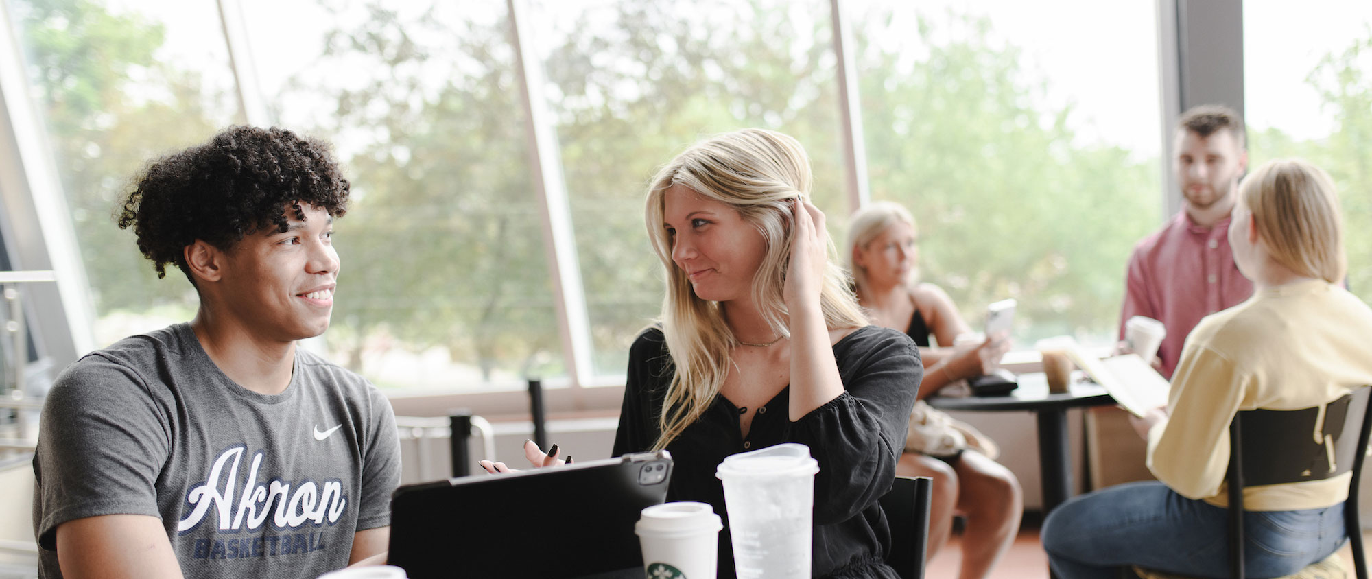 Two students talk about admissions requirements in the Student Union.