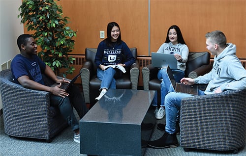 Four students studying together inside Williams Honor College Building.