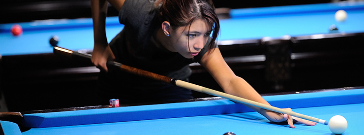 Student playing billiards